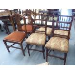 A set of four late 19thC mahogany framed spindled back chairs, the later fabric covered seats raised