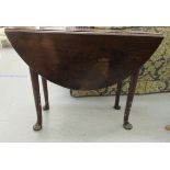 A late Georgian mahogany drop leaf table with an oval top and two fall flaps, raised on turned,