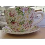 A novelty china planter, fashioned as an oversize teacup and saucer