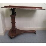 A late 19thC mahogany reading table with an offset, height adjustable column, on a tapered plinth