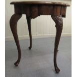 A 1930s satinwood inlaid quarter veneered walnut occasional table with a moulded serpentine outlined