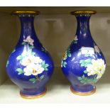 A pair of modern Oriental cloisonné vases of bulbous, pedestal design, decorated with flowering