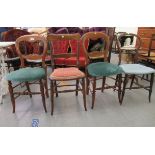 A pair of late Victorian mahogany framed balloon back side chairs; and two others with variously
