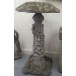 A composition stone pedestal with a mushroom design top, decorated with mice and foliage  28"h