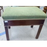 A mid 20thC mahogany framed music stool with a late fabric covered cushioned seat, raised on