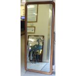 A Victorian style dressing mirror, set in a plain, cushion moulded mahogany frame  63" x 27"