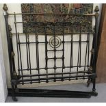 A Victorian black painted iron and lacquered brass bed frame of tubular design with finials and