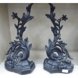 A pair of 19thC style black painted andirons of foliate scrolled design  19"h