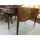 A 19thC mahogany Pembroke table, incorporating an end drawer and facsimile on the reverse, raised on