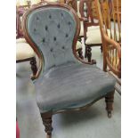 A late Victorian mahogany showwood framed salon chair, part button upholstered in blue fabric,