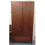 A modern oak wardrobe with two doors and a drawer, raised on block feet  82"h  41"w