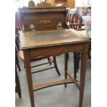 An Edwardian string inlaid mahogany clerks desk with a hinged lid, raised on square, tapered legs