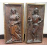 A pair of late 19thC Flemish mahogany panels, carved in high relief with a standing falconer and a