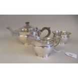 A three piece silver tea set of footed bowl design with gadrooned borders  comprising a teapot