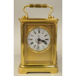 A 20thC lacquered brass cased carriage timepiece, having bevelled glass panels and a folding top