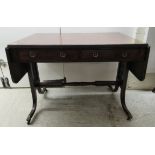 A 19thC mahogany sofa table with ebony string inlaid decoration, the top having a reeded edge,