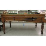 20thC mahogany and oak bar billiards table with a slate bed and green baize playing surface,