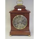 A Georgian style brass string inlaid and mounted mahogany cased bracket clock with a folding top