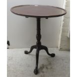 A 19thC mahogany pedestal table, the turned top over a ring turned column with a foliate carved