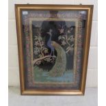 A 20thC Asian mixed media tapestry picture, a peacock standing amid flowering branches and elaborate