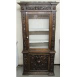A 19thC Continental walnut cabinet, having a straight cornice, over a glazed panelled door,