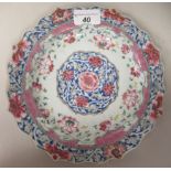 An 18thC Chinese porcelain wavy edged plate, decorated in colours with stylised floral designs  9"