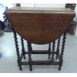 A 1920s oak drop leaf tea table, raised on barleytwist legs  27"h  23"w