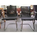 A pair of modern chrome finished cantilever design chairs, each with a woven mesh material back