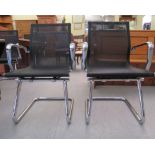 A pair of modern chrome finished cantilever design chairs, each with a woven mesh material back