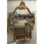 A modern mirror, the shaped plate set in a Regency design moulded gilt frame  18" x 14"