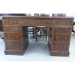 A late Victorian mahogany nine drawer, twin pedestal desk  29"h  48"w