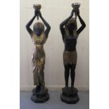 A pair of 20thC bi-coloured bronze freestanding lamps, fashioned as ancient Egyptian figures, each