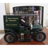 A modern diorama of a late Victorian High Street pharmacy  10"h  13"w; and a delivery vehicle,