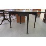 A George III mahogany drop leaf table, raised on turned, tapered legs and pad feet  28"h  36"w