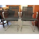 A pair of modern chrome finished cantilever design chairs, each with a woven mesh material back