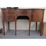 An Edwardian string inlaid mahogany, serpentine front sideboard, the top over three drawers and a