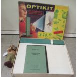 An Optikit Projector kit  boxed; and a clockwork fabric covered toy monkey  7"h