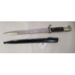 A World War II bayonet  bears indistinct marks  the blade 10"L with a cast metal sheath