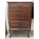 A 1930s mahogany six drawer sheet music cabinet, raised on cabriole legs  34"h  21"w