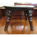 An 18thC stained oak stool, the top raised on four pegged feet  5.5"h  8"dia