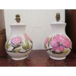 A pair of Moorcroft pottery table lamps, decorated in relief in pastel tones with flora  12"h