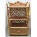 A caned wicker three tier display unit with a base drawer  38"h  22"w