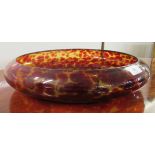 A modern red and yellow mottled glass bowl of shallow form  16"dia