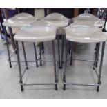 A stacking set of five Steelux GLC design stools with moulded grey plastic seats and painted metal