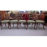 A set of five mid Victorian walnut framed balloon and carved bar back dining chairs, the later
