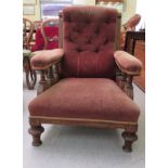 An Aesthetic Movement oak showwood framed salon chair, upholstered in red/brown fabric, raised on