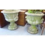 A pair of composition stone garden pedestal urns  25"h  22"dia