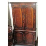 A modern flame mahogany finished cabinet, the upper section with a pair of panelled doors with an