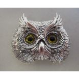 A Sterling silver owl's head brooch with glass eyes