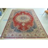 A Persian rug with floral motifs, on a red ground  80" x 96"